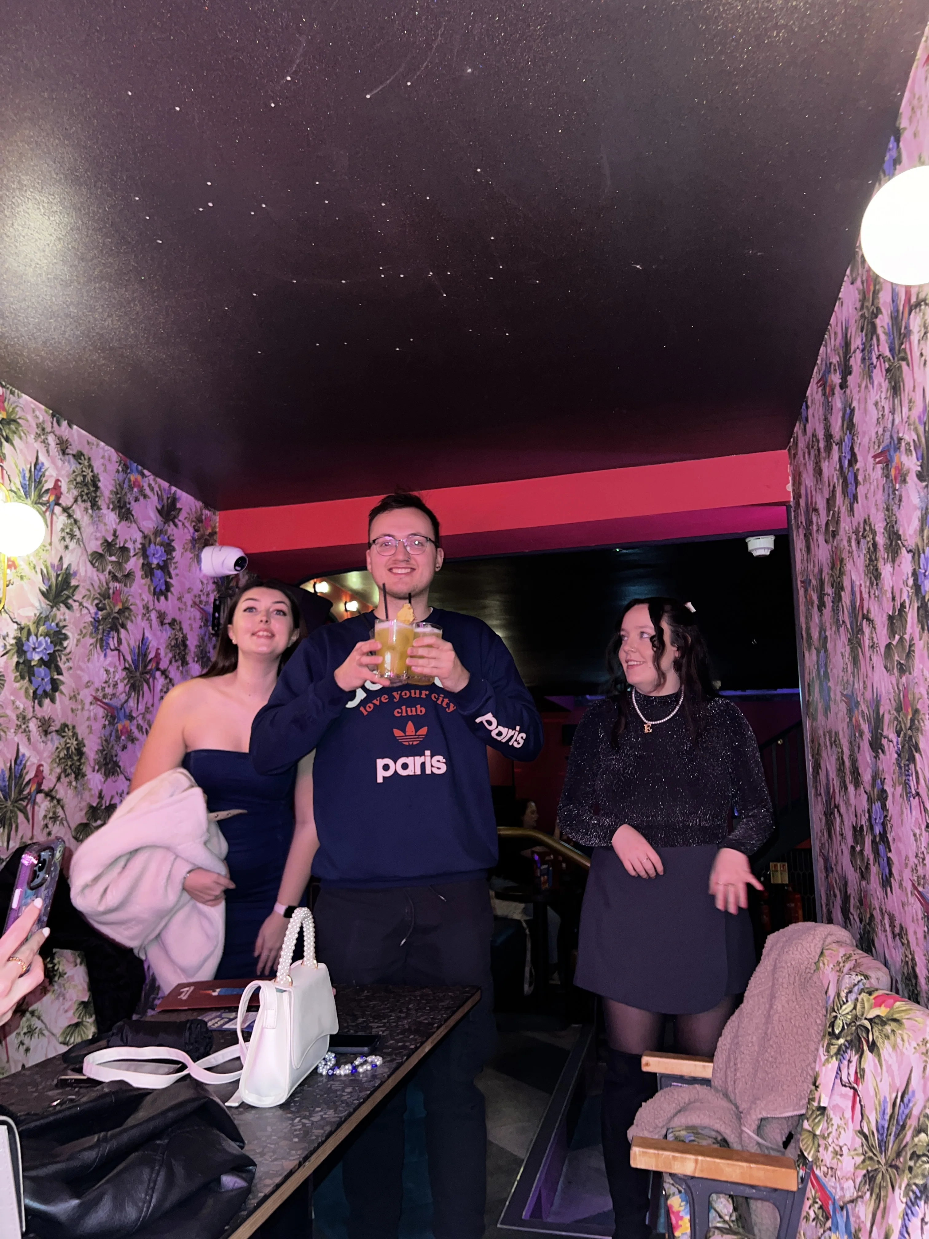 A friend holding drinks at Tequila Mockingbird